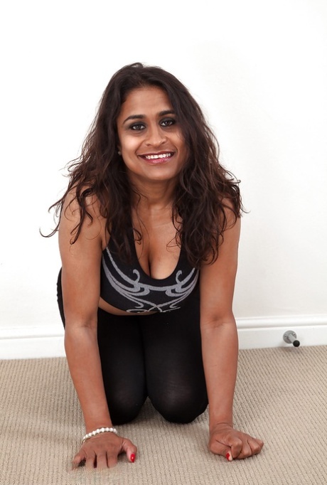 Dirty-minded mature lassie undressing and exposing her shaggy twat