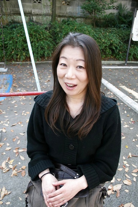 Outdoor posing scene featuring horny Asian mature Yoshiko Makihara