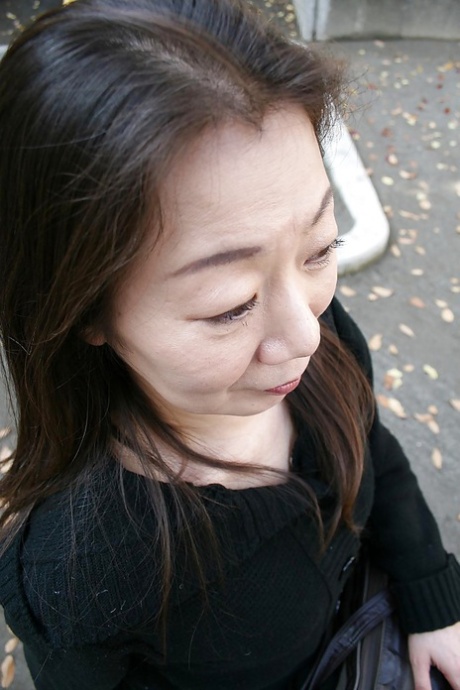Outdoor posing scene featuring horny Asian mature Yoshiko Makihara
