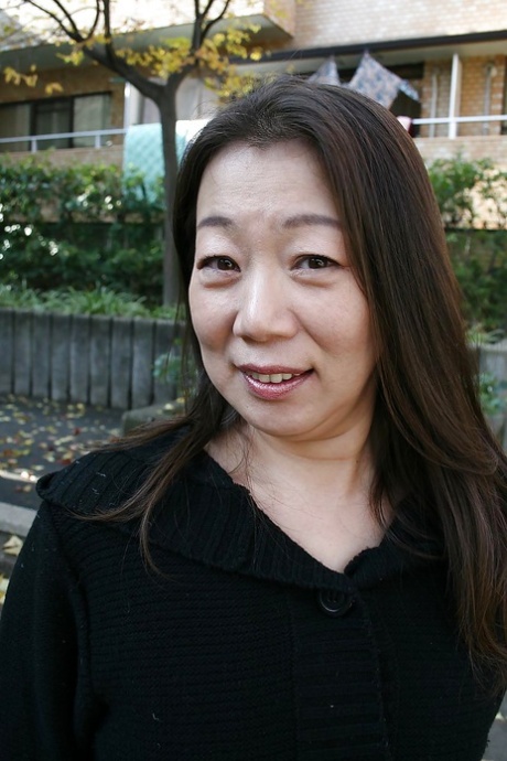 Outdoor posing scene featuring horny Asian mature Yoshiko Makihara