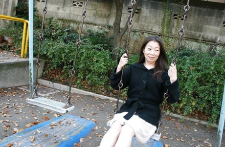 Outdoor posing scene featuring horny Asian mature Yoshiko Makihara