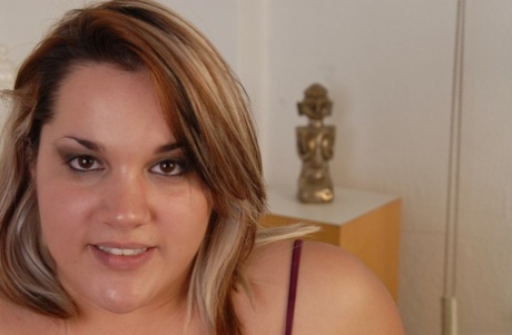 Fatty chick with tattoos is undressing hot and playing with nipples