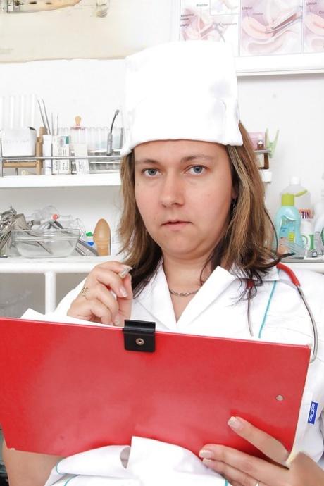 Chubby blonde nurse Iva Wild posing in hot uniform and pantyhose