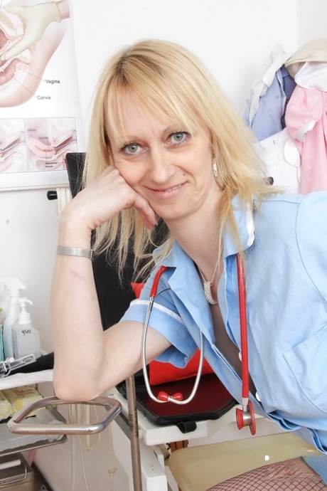 Mature nurse Nelly stripping off uniform and masturbating shaved pussy