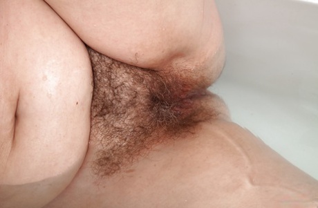 Older lady Christina X baring flabby stomach and hairy pussy