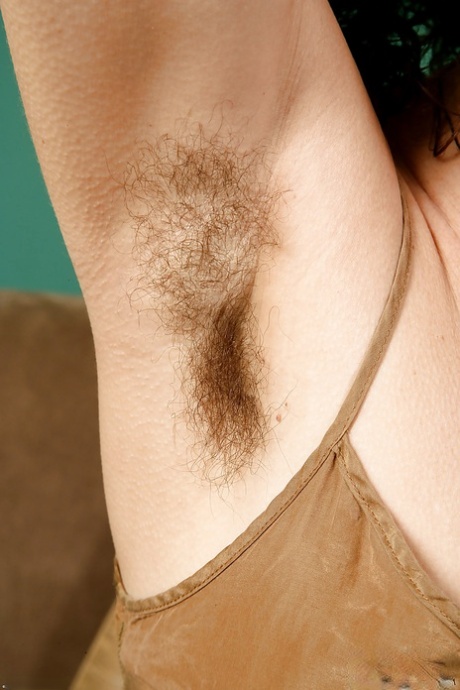 Aged hirsute model Sunshine displaying hairy armpits up close