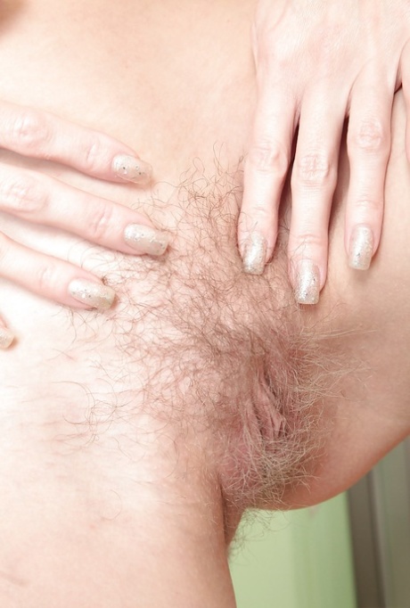 Mature woman with tiny tits showing off bare ass before masturbating pussy