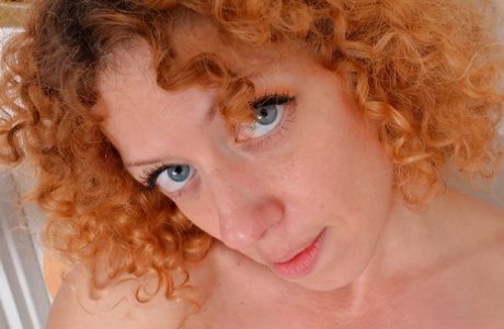 Mature redhead with great legs freeing hairy cunt from panties