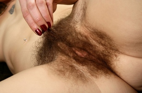 Older hirsute model Sunshine proudly shows off her all natural vagina