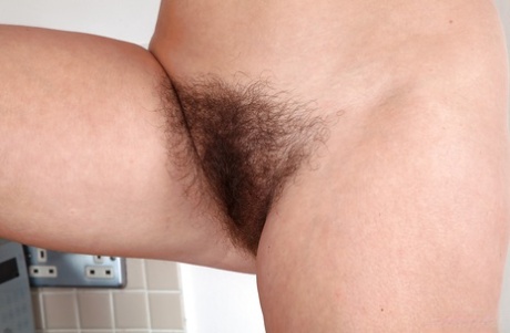 Blonde mature woman Elle Macqueen spreads legs to show her hairy beaver