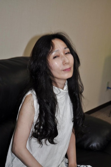 Asian mature lassie Nobue Toyoshima stripping and teasing her hairy twat