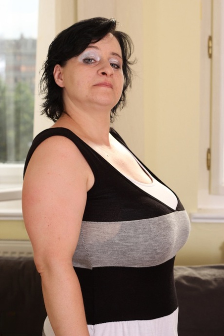 Mature woman Ekaterina puts a fat dick between her big tits & sucks it