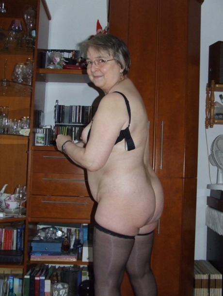 Chubby granny with glasses Sybille stripping naked & toying her fat pussy