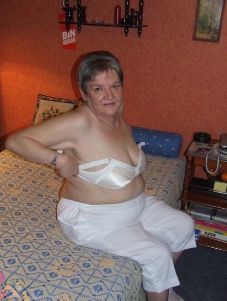 Fat granny Uschi doffs her clothes, poses naked and masturbates on a bed