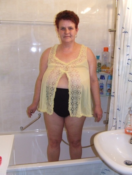 Chubby housewife Ingeborg plays with her saggy breasts in the bathroom