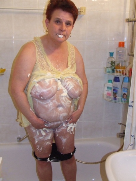 Chubby housewife Ingeborg plays with her saggy breasts in the bathroom