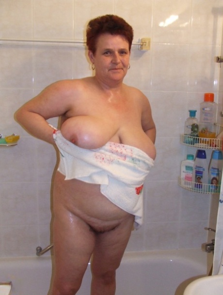 Chubby housewife Ingeborg plays with her saggy breasts in the bathroom
