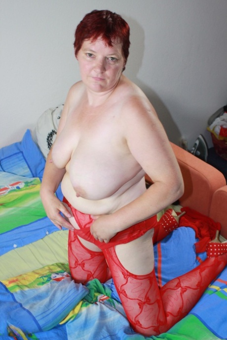 Fat amateur mature Ilona removes her red lingerie and plays with toys