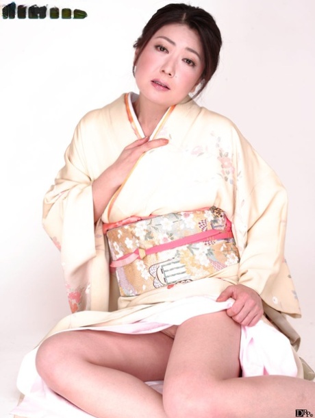 Japanese lady Ayano Murasaki receives a facial while posing in her lingerie