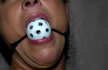 Black-haired mature India Summer gets gagged & toyed in a concrete room