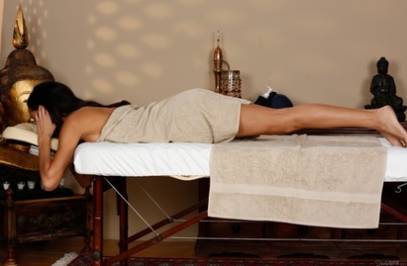 Petite brunette Chloe Amour shows her natural tits in the massage parlor