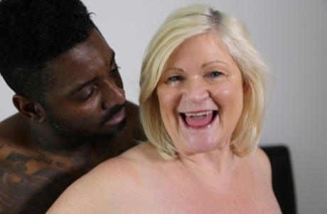 Chubby blonde granny Lacey Starr tastes a black cock before riding it