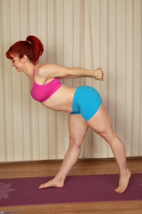 Flexible ginger Andrea Rosu strips down naked on a yoga mat & shows her body