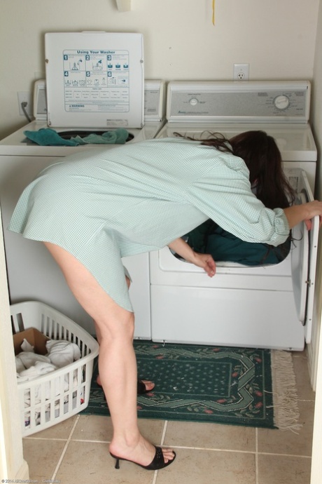 Mature housewife Celeste Carpenter masturbates in front of the washing machine