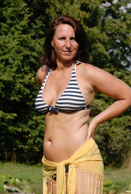 Amateur MILF Demi unveils her big tits and rubs her hot hole outdoors