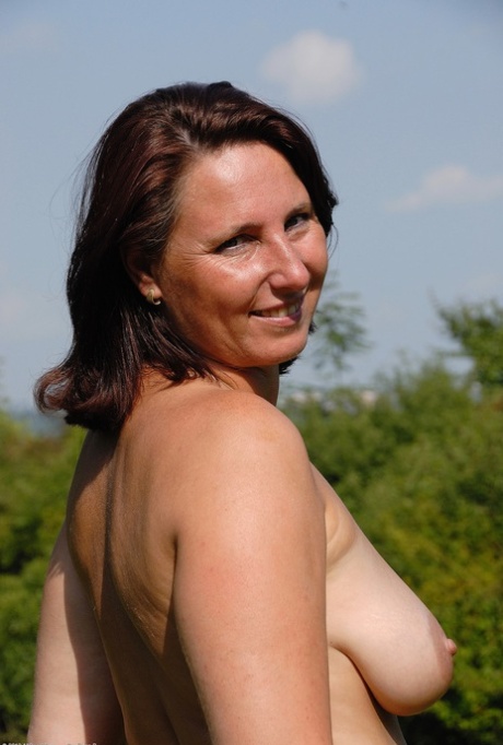 Amateur MILF Demi unveils her big tits and rubs her hot hole outdoors