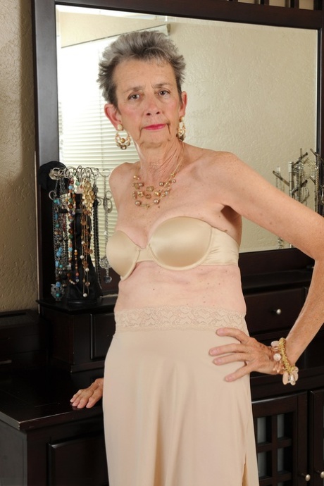Slim granny Cassie doffs her dress and flaunts her bushy vagina