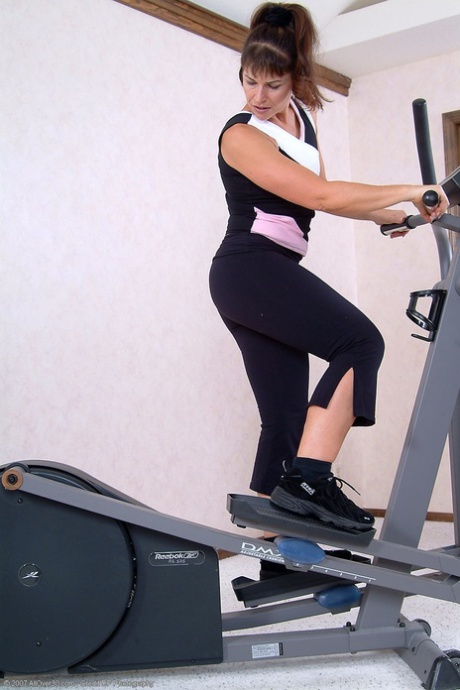 Hot MILF Andie strips naked and shows off her big ass at the gym
