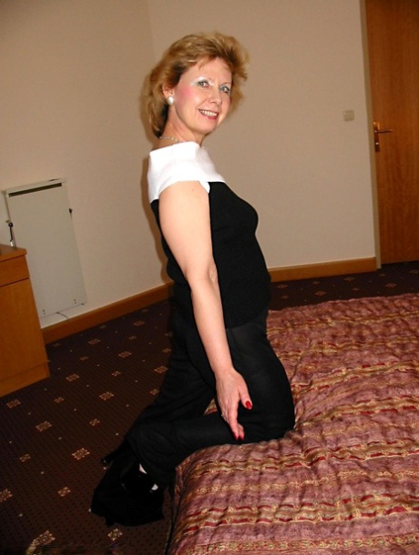 Mature blonde Mischa unleashes her big natural tits and toys her beaver