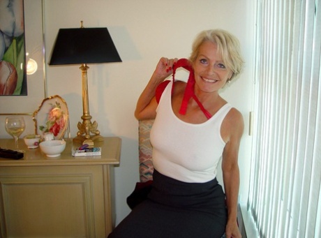 Mature lady Justine exposes her saggy tanned tits while smoking a cigarette