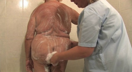 BBW granny Clara lets her lesbian caregiver finger her horny pussy