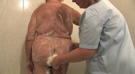 BBW granny Clara lets her lesbian caregiver finger her horny pussy