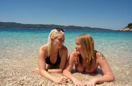 Moms with big booties Mackenzie Page and Miss Melissa pose nude on the beach