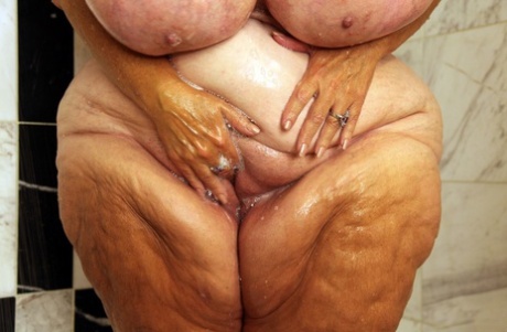 Amateur BBW Suzie Q washing her extra large tanned natural tits
