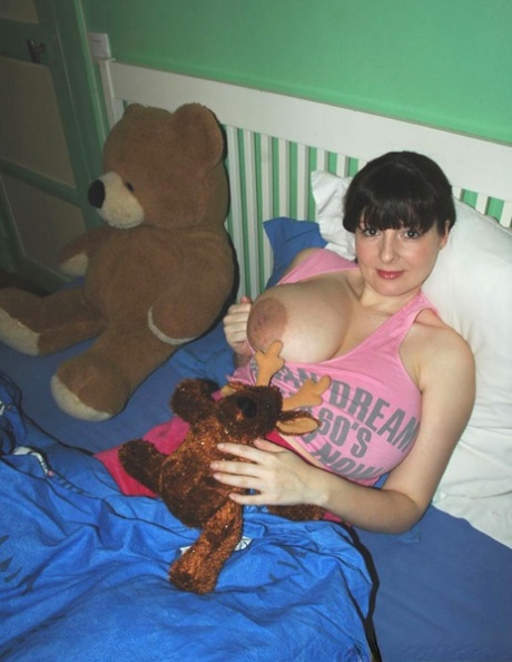 Dark haired amateur Lorna Morgan shows her huge boobs and stretches her ass
