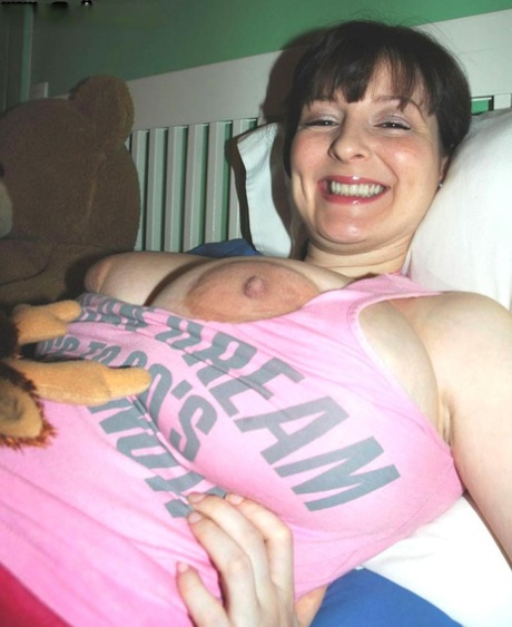 Dark haired amateur Lorna Morgan shows her huge boobs and stretches her ass