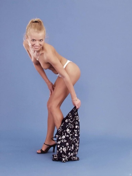 Cute blonde Dora Venter poses in her hot dresses & white panties in a solo