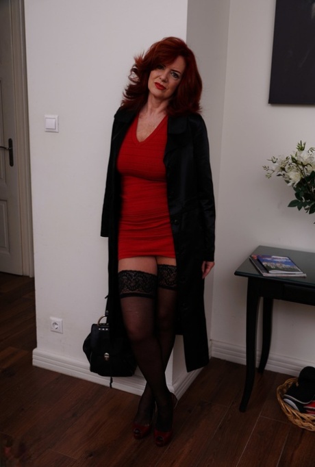 Redhead mature Andi James exposes her black undies wearing lacy stockings