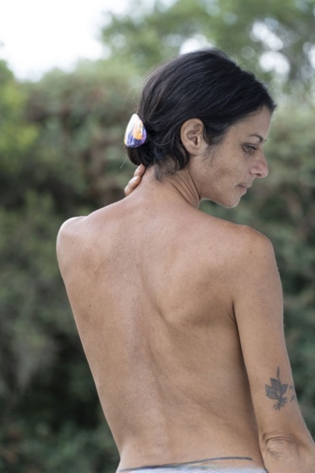 Amateur American MILF Bruna strips outside & flaunts her hairy crotch