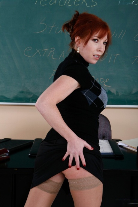 Sinful redhead teacher Brittany O'Connell masturbates in the classroom
