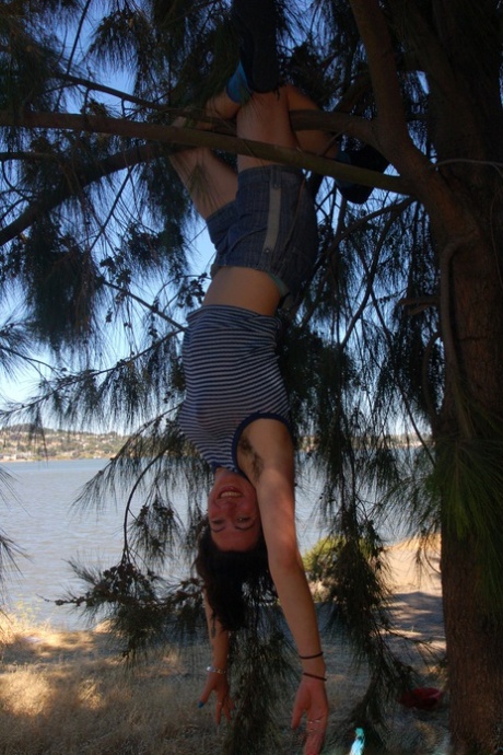 Amateur Sadie Lune undressing and spreading her bush up close under a tree