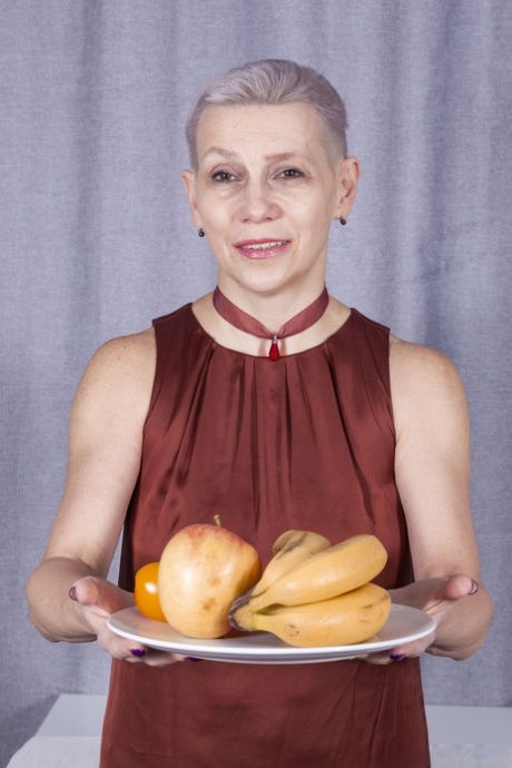 Short-haired granny Marry plays with her long pussy hair as she strips