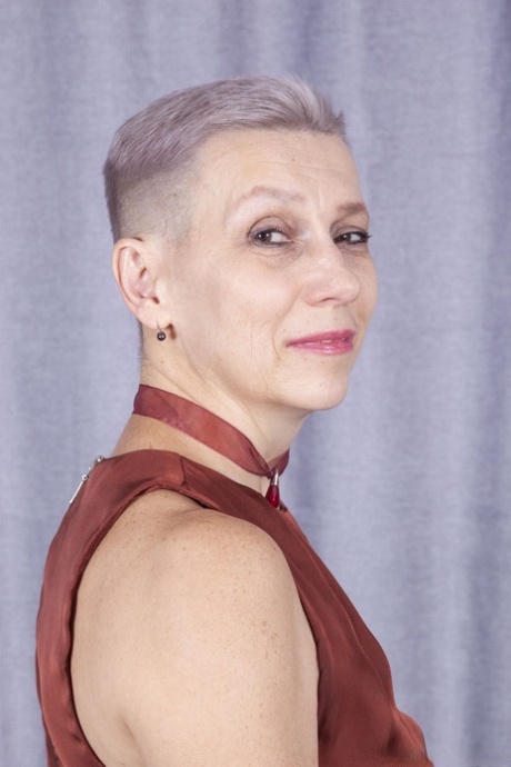 Short-haired granny Marry plays with her long pussy hair as she strips