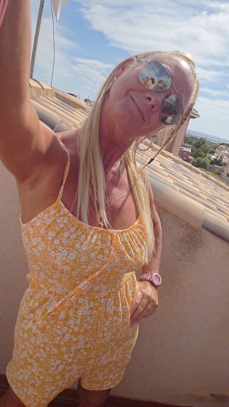 Mature Spanish pornstar Natalie K unveiling her big juicy tits on the balcony
