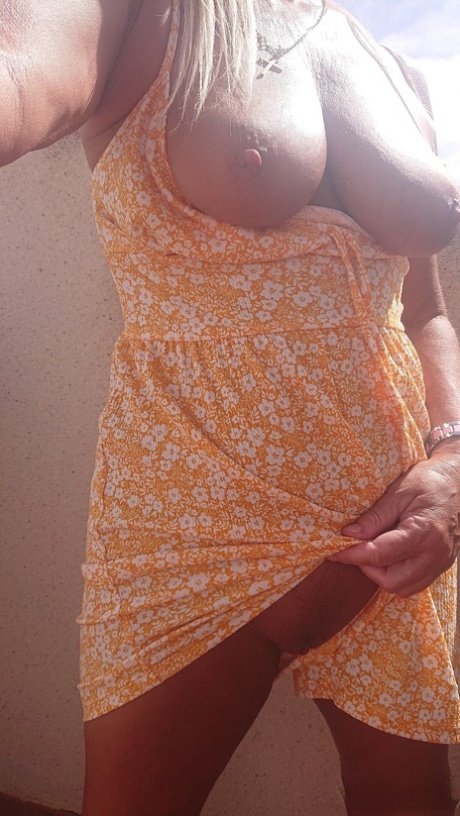 Mature Spanish pornstar Natalie K unveiling her big juicy tits on the balcony