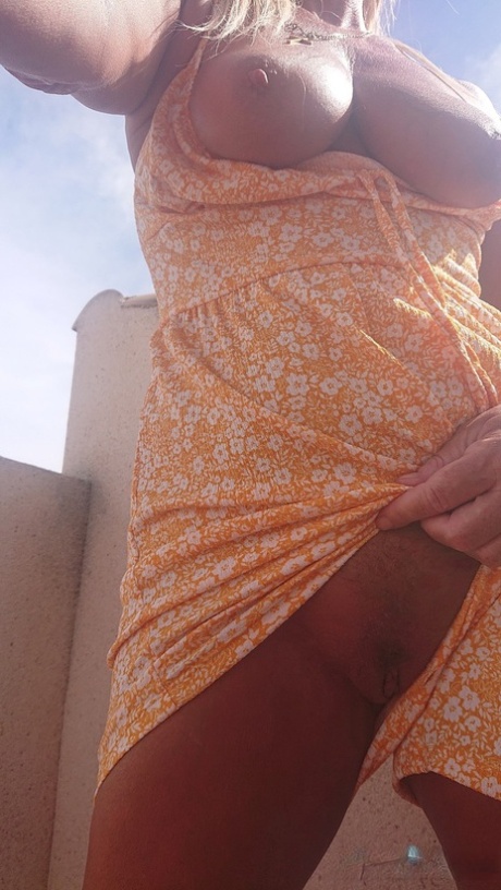 Mature Spanish pornstar Natalie K unveiling her big juicy tits on the balcony